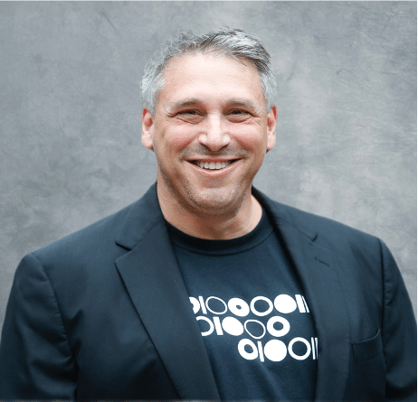 Reach Higher: Interview with JT Kostman, CEO of ProtectedBy.AI 1 JT Grey Background Headshot.png